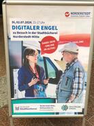 Ein Foto von einem Aufsteller mit Werbung f&uuml;r den Besuch des Digitalen Engel in Norderstedt.