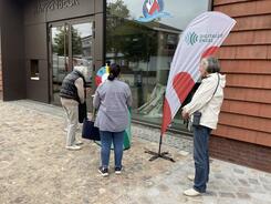 Drei Seniorinnen warten an unserem Infostand vor der &ouml;rtlichen Bibliothek.