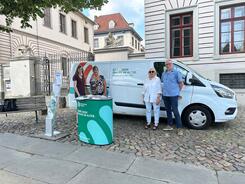 Petra (links) posiert mit drei Mitgliedern des L&uuml;neburgers Seniorenbeirats vor dem Info-Mobil des Digitalen Engel am Info-Stand.