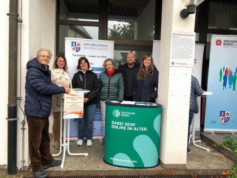 Petra steht mit B&uuml;rgermeisterin Angelika Beckenbach und Vertreter:innen der Fachstelle Leben im Alter, dem Pflegest&uuml;tzpunkt Kreis Bergstra&szlig;e, dem Kreisseniorenbeirat sowie PauLA f&uuml;r ein Gruppenbild.